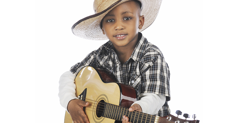 young boy in cowboy hat playing guitar